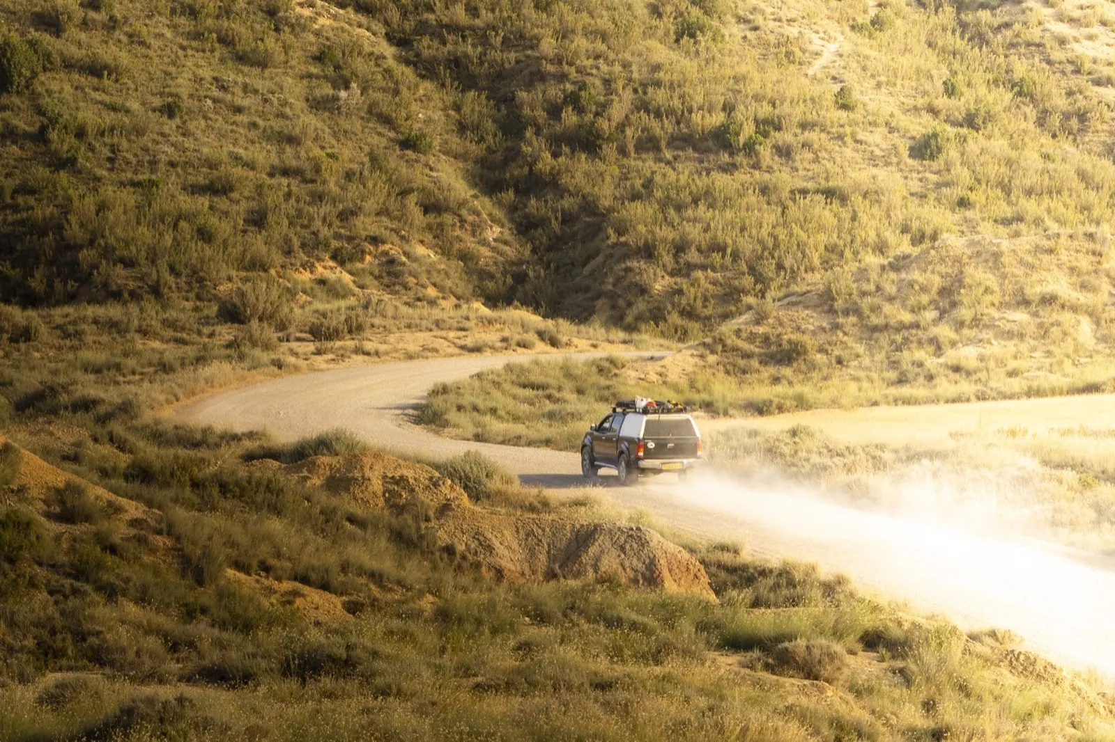 Our 4x4 on a dusty track through dry hills