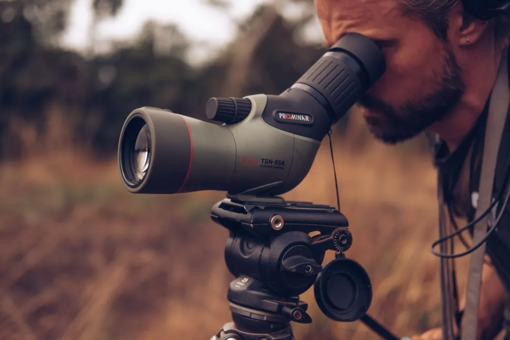 Axel looking through a spotting scope in Liberia